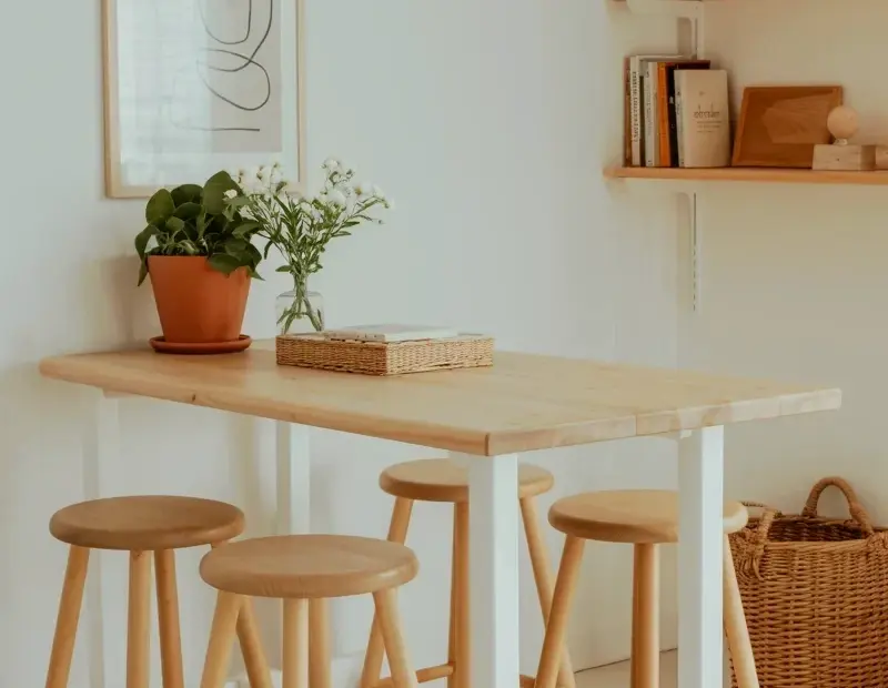 Minimalist Kitchen Nook with Natural Wood Table and Bar Stools
