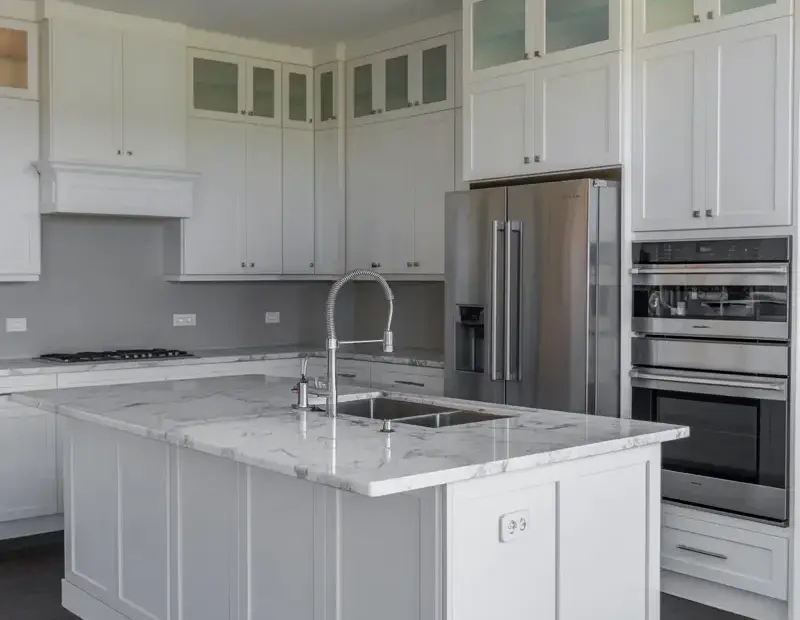 White Shaker Kitchen with Marble Island and Glass Upper Cabinets for Winter Hosting